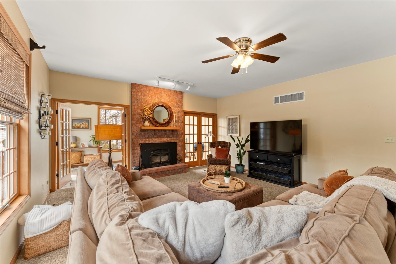 1303 Hickory Tree Court Mahomet, IL 61853 - Photo 23 of 63 a living room with furniture a fireplace and a flat screen tv