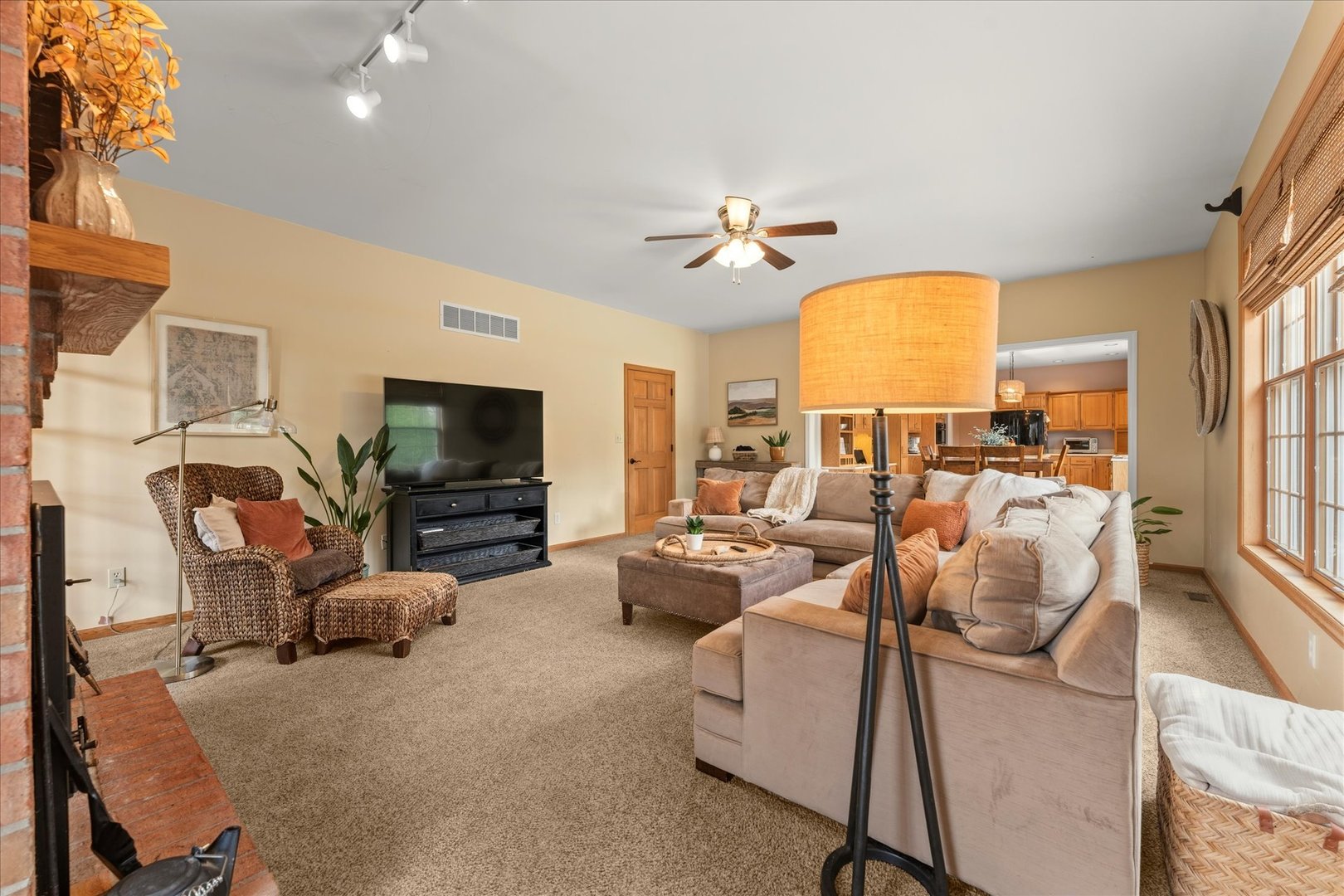 1303 Hickory Tree Court Mahomet, IL 61853 - Photo 25 of 63 a living room with furniture fireplace and a flat screen tv