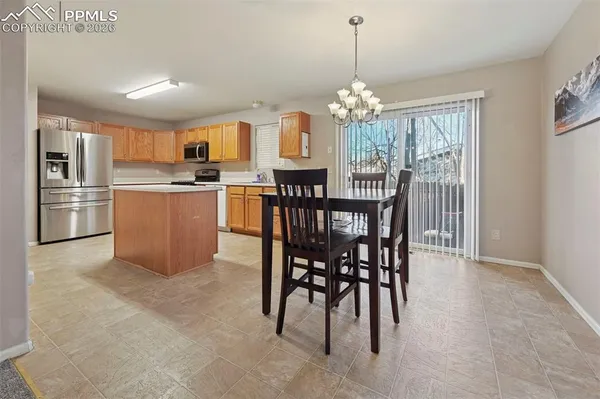 a view of a dining room with furniture window and outside view