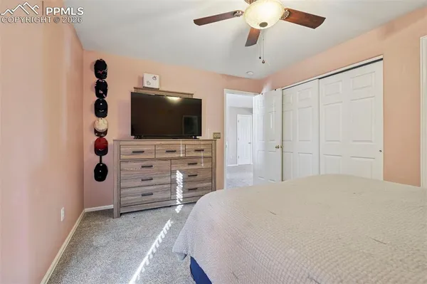 a bedroom with a bed and flat screen tv