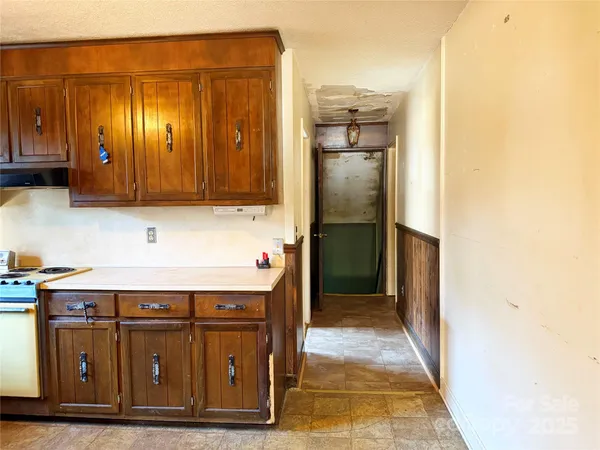 a kitchen with stainless steel appliances granite countertop a sink a stove and refrigerator