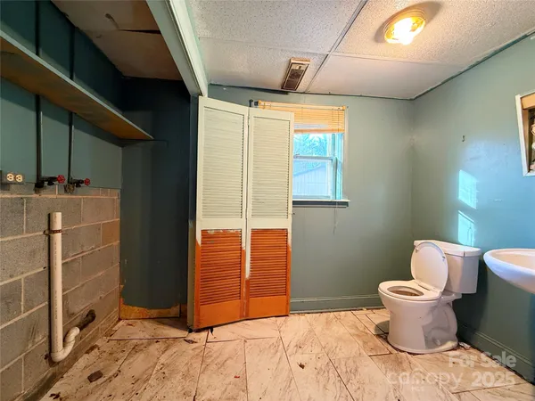 a bathroom with a toilet sink and mirror