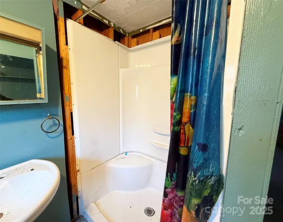 an empty room with a window and fireplace