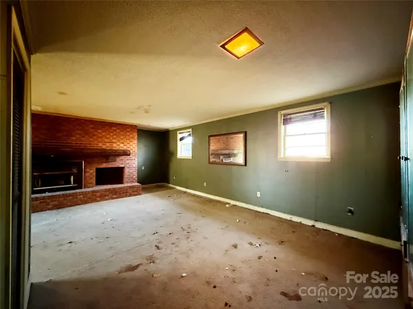 a view of empty room with fireplace