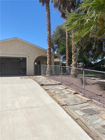 a outdoor space of a house with basket ball court
