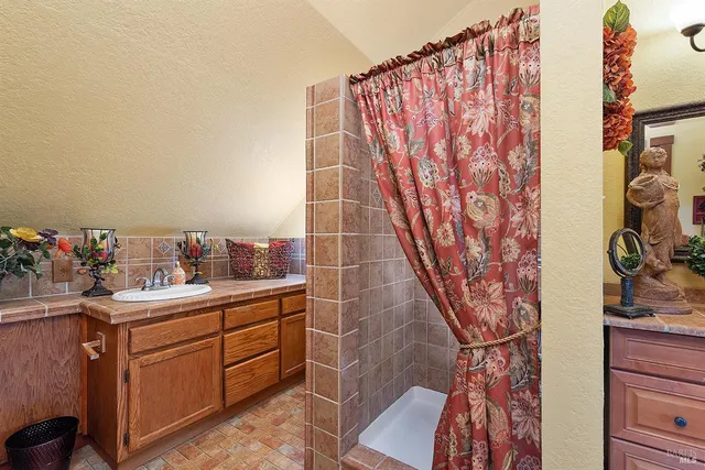 a bathroom with a toilet and shower curtain
