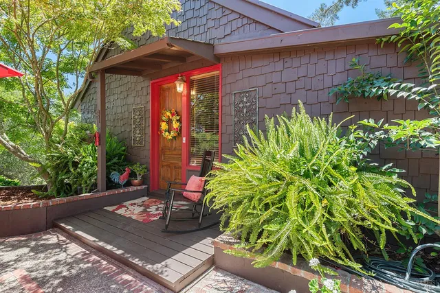 a living room with furniture a fireplace and a large window