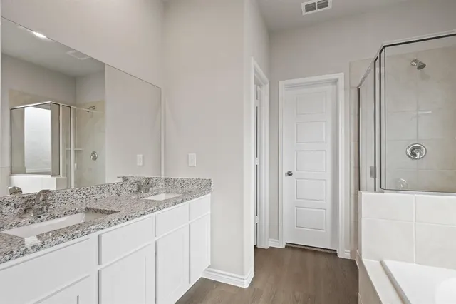 a bathroom with a bathtub and a shower