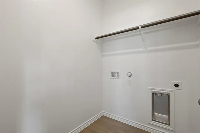 an empty room with windows and ceiling fan