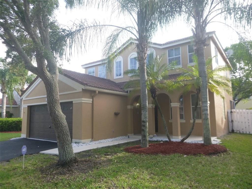 745 Falling Water Road Weston, FL 33326 - Photo 1 of 34 a front view of a house with a yard