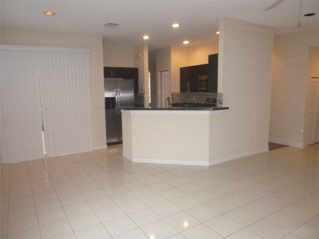 745 Falling Water Road Weston, FL 33326 - Photo 14 of 34 an empty room with kitchen view