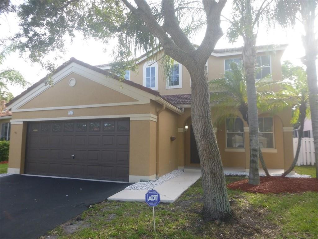 745 Falling Water Road Weston, FL 33326 - Photo 2 of 34 a front view of a house with a yard