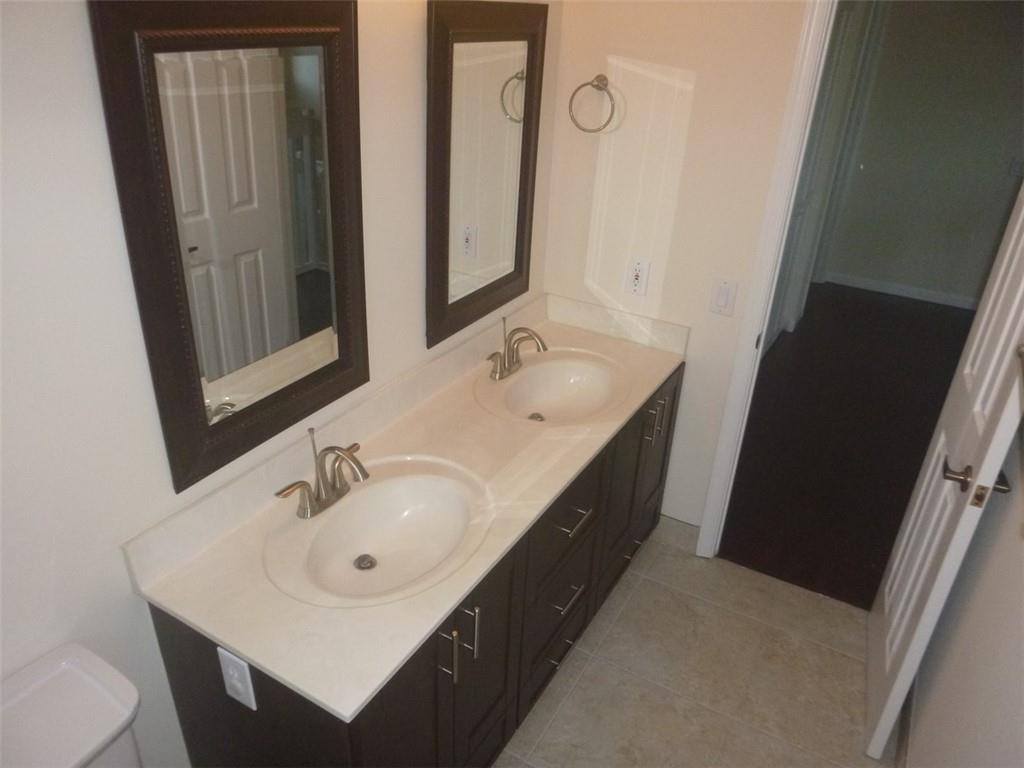 745 Falling Water Road Weston, FL 33326 - Photo 31 of 34 a bathroom with a sink and a mirror