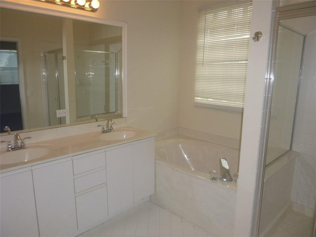 745 Falling Water Road Weston, FL 33326 - Photo 34 of 34 a bathroom with a tub sink and mirror
