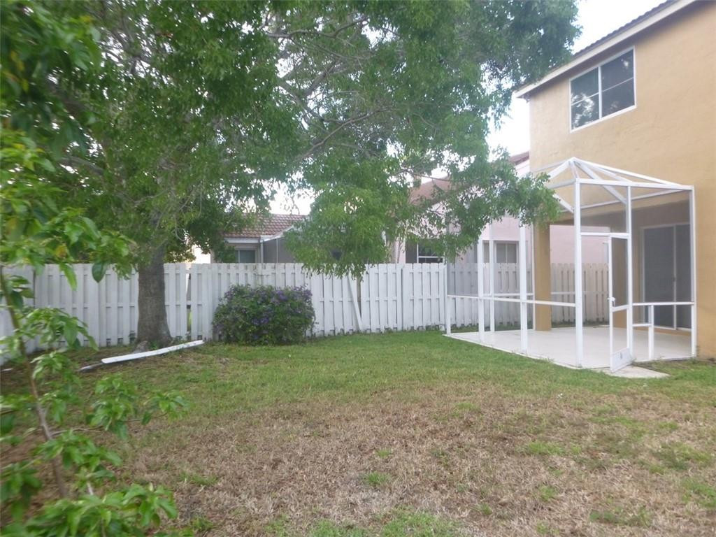 745 Falling Water Road Weston, FL 33326 - Photo 5 of 34 a view of a backyard with white house