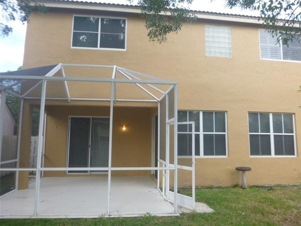 745 Falling Water Road Weston, FL 33326 - Photo 6 of 34 a view of house with backyard and windows