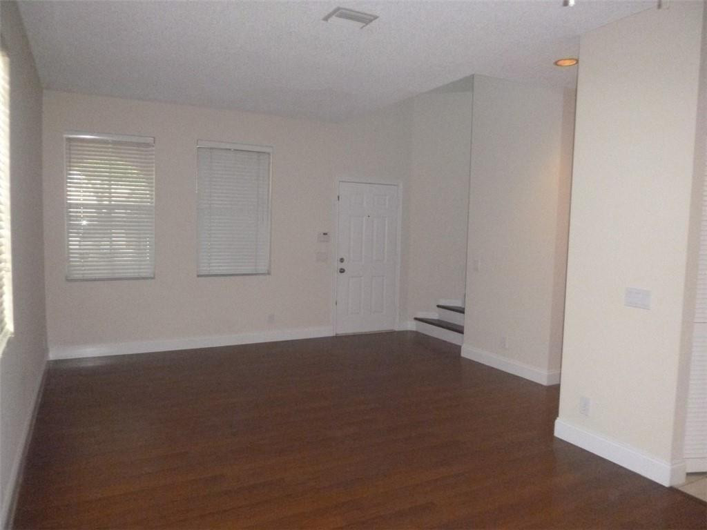 745 Falling Water Road Weston, FL 33326 - Photo 8 of 34 an empty room with an empty space and wooden floor
