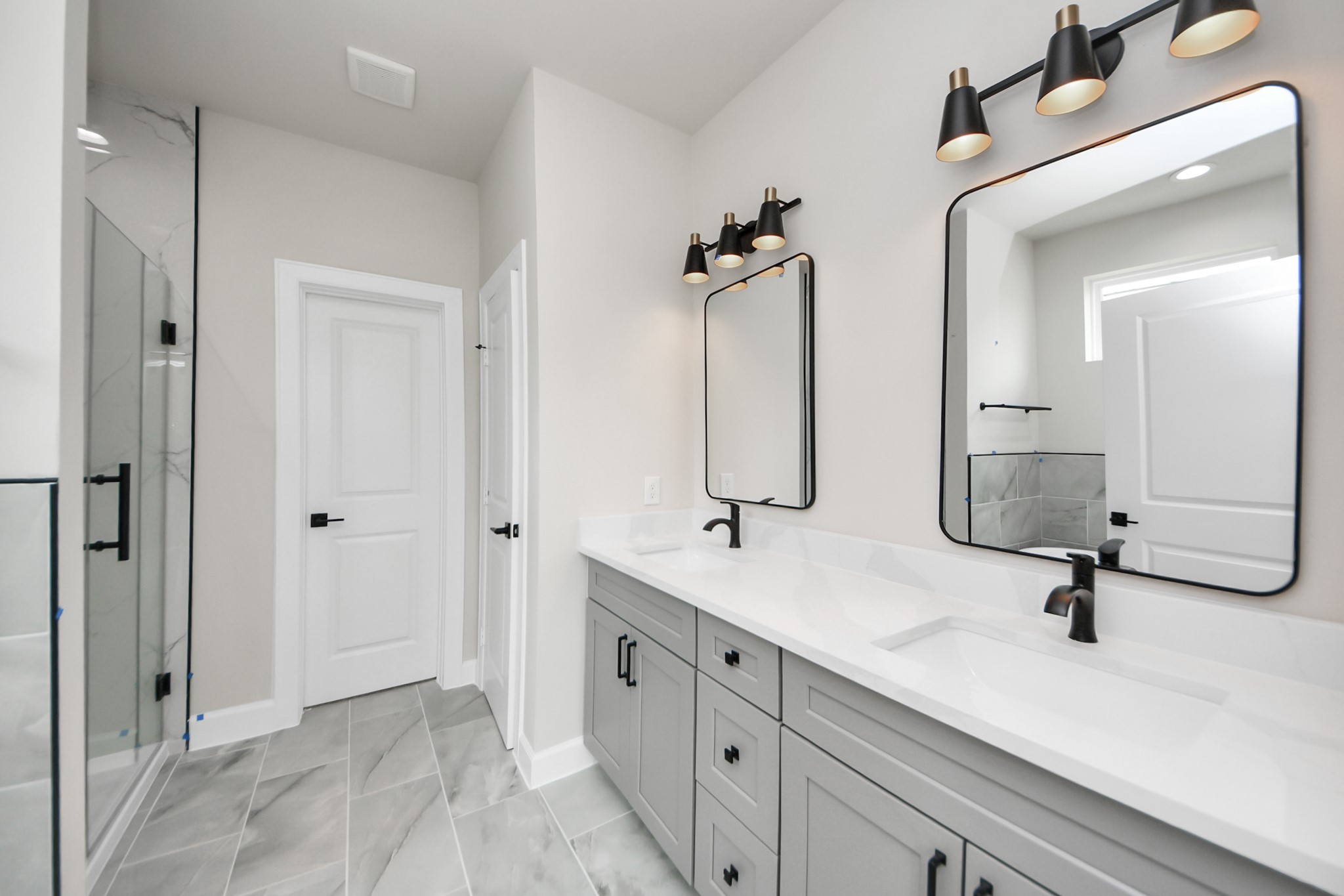3110 Dawson Lane, Unit A Houston, TX 77051 - Photo 15 of 32 a bathroom with a double vanity sink a mirror and shower