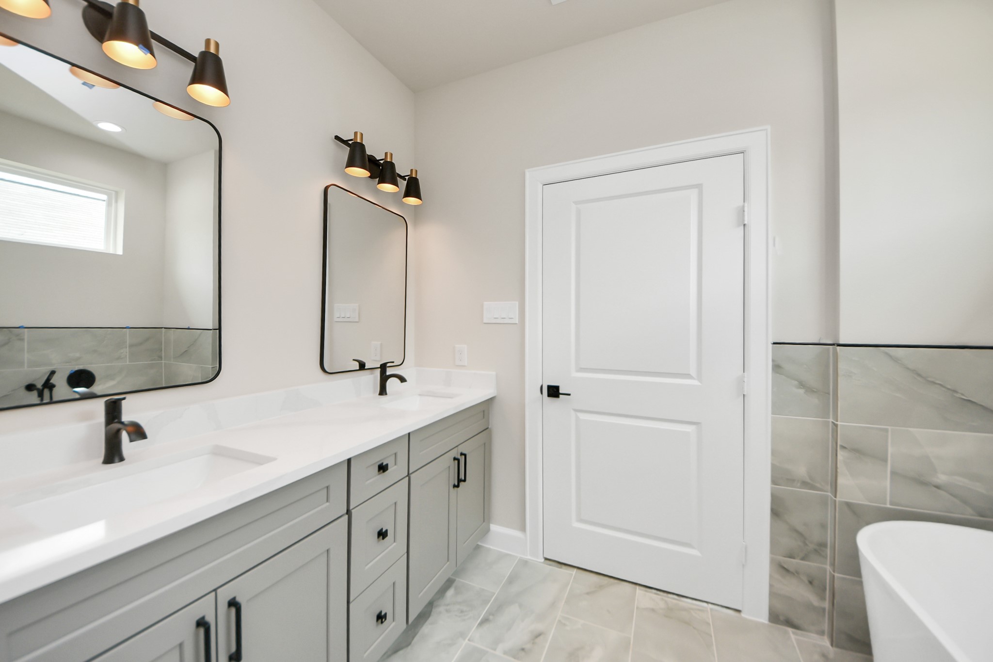 3110 Dawson Lane, Unit A Houston, TX 77051 - Photo 16 of 32 a bathroom with a double vanity sink a mirror and a shower