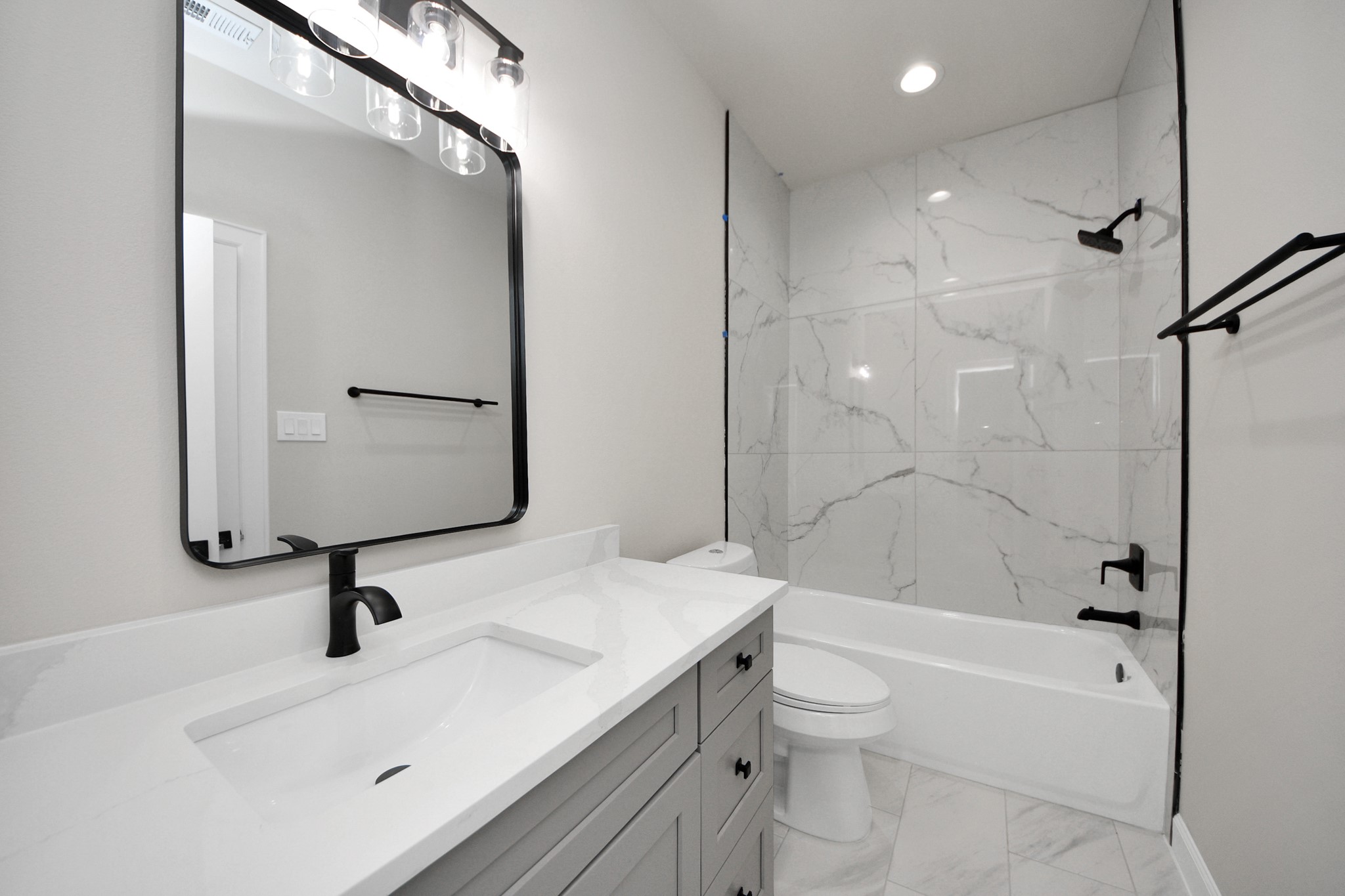 3110 Dawson Lane, Unit A Houston, TX 77051 - Photo 25 of 32 a bathroom with a sink a toilet and a large mirror