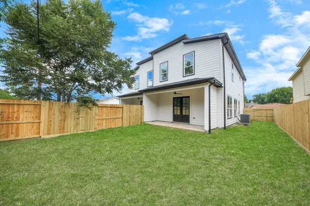 a view of backyard of house with green space