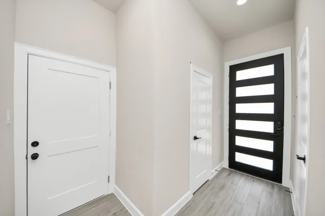 a view of empty room with wooden floor