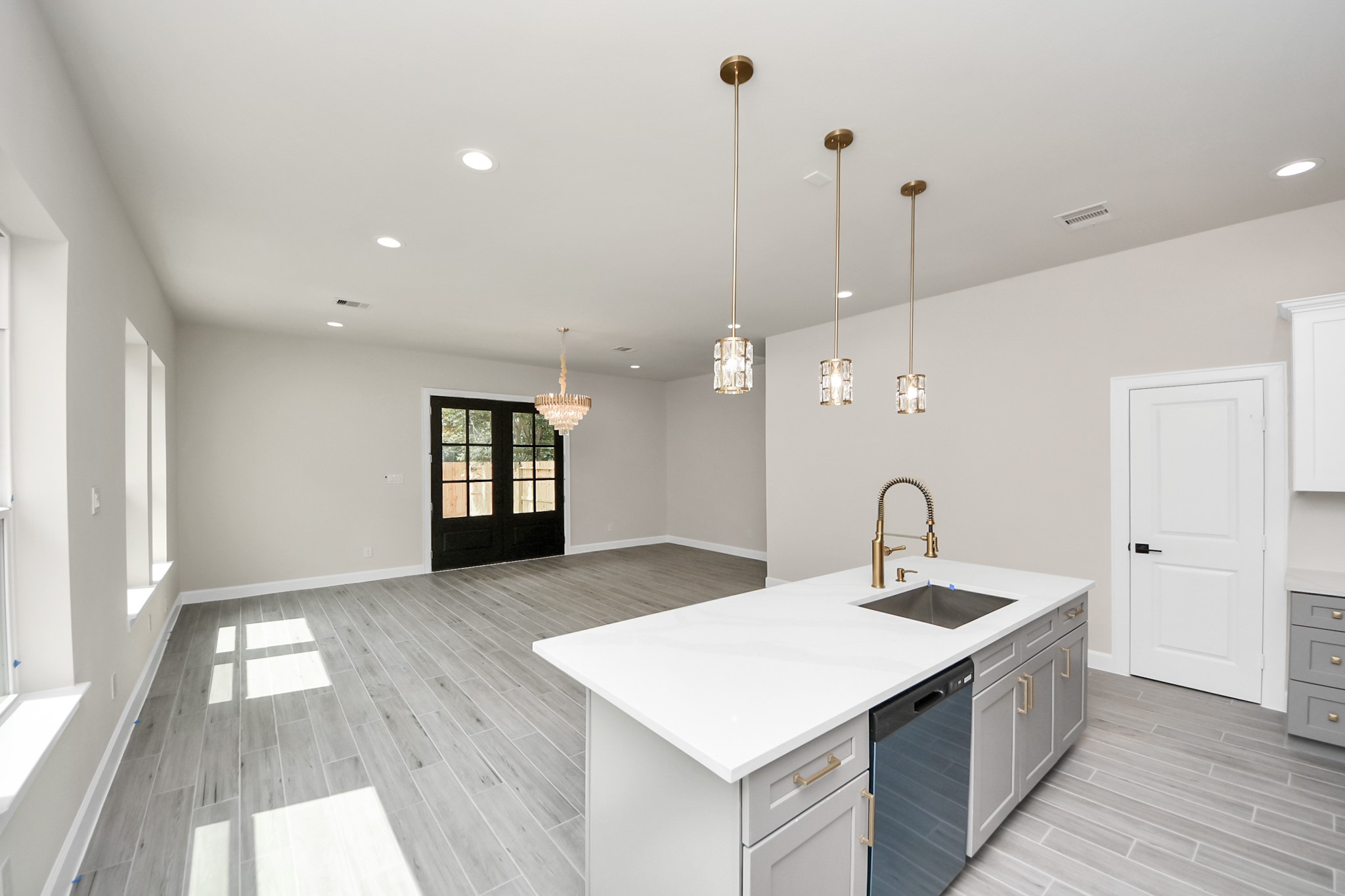 3110 Dawson Lane, Unit A Houston, TX 77051 - Photo 8 of 32 a large white kitchen with a sink a refrigerator and a fireplace