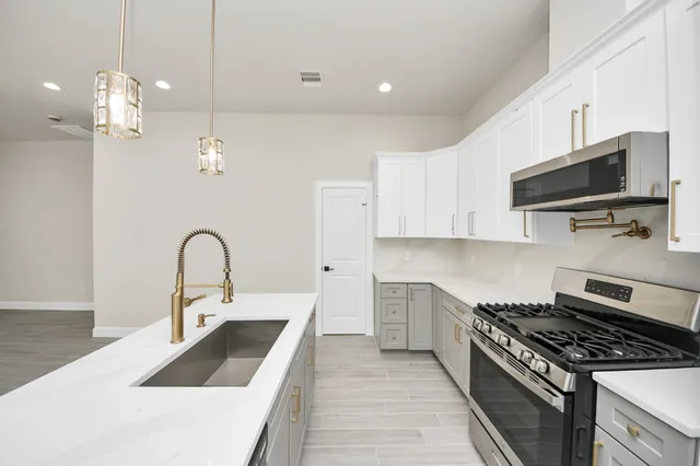 a kitchen that has a sink and a stove