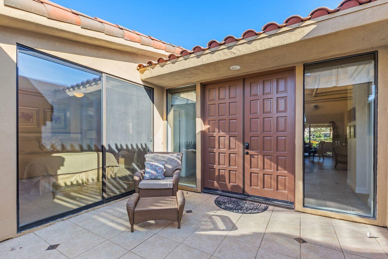 45250 Vista Santa Rosa Indian Wells, CA 92210 - Photo 13 of 28 a porch with a table and chairs