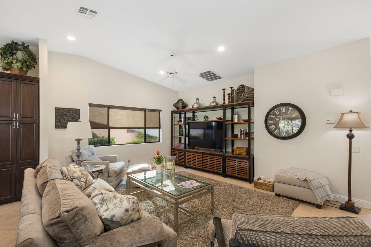 45250 Vista Santa Rosa Indian Wells, CA 92210 - Photo 16 of 28 a living room with furniture a clock and a table