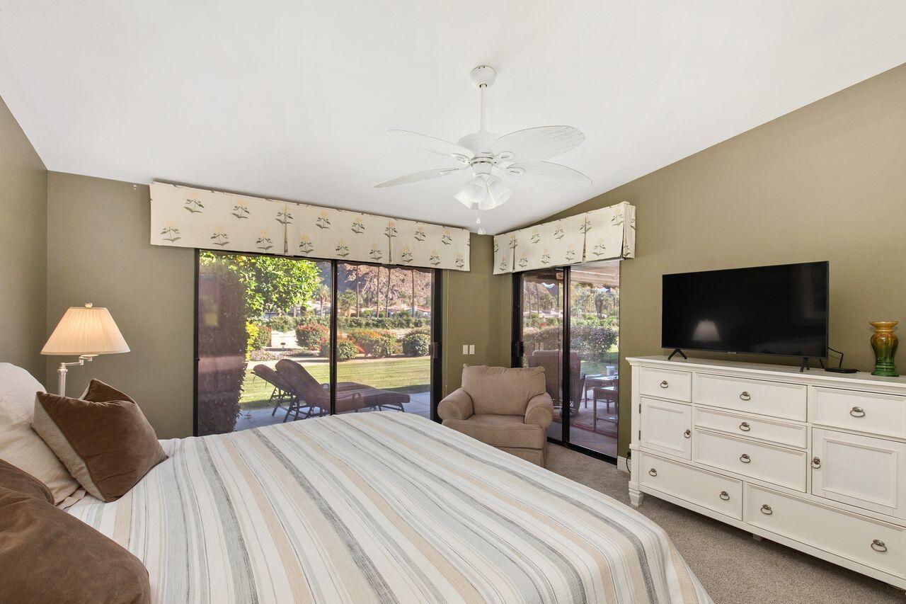 45250 Vista Santa Rosa Indian Wells, CA 92210 - Photo 22 of 28 a bedroom with a bed and a flat screen tv