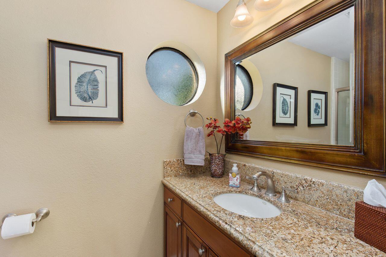 45250 Vista Santa Rosa Indian Wells, CA 92210 - Photo 24 of 28 a bathroom with a granite countertop double vanity and a mirror