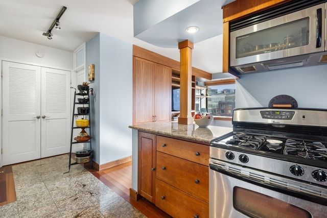 a kitchen with stainless steel appliances granite countertop a stove and a sink