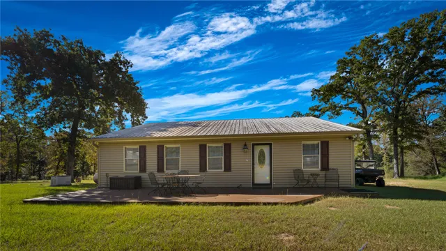 a kitchen with a sink a refrigerator and white cabinets
