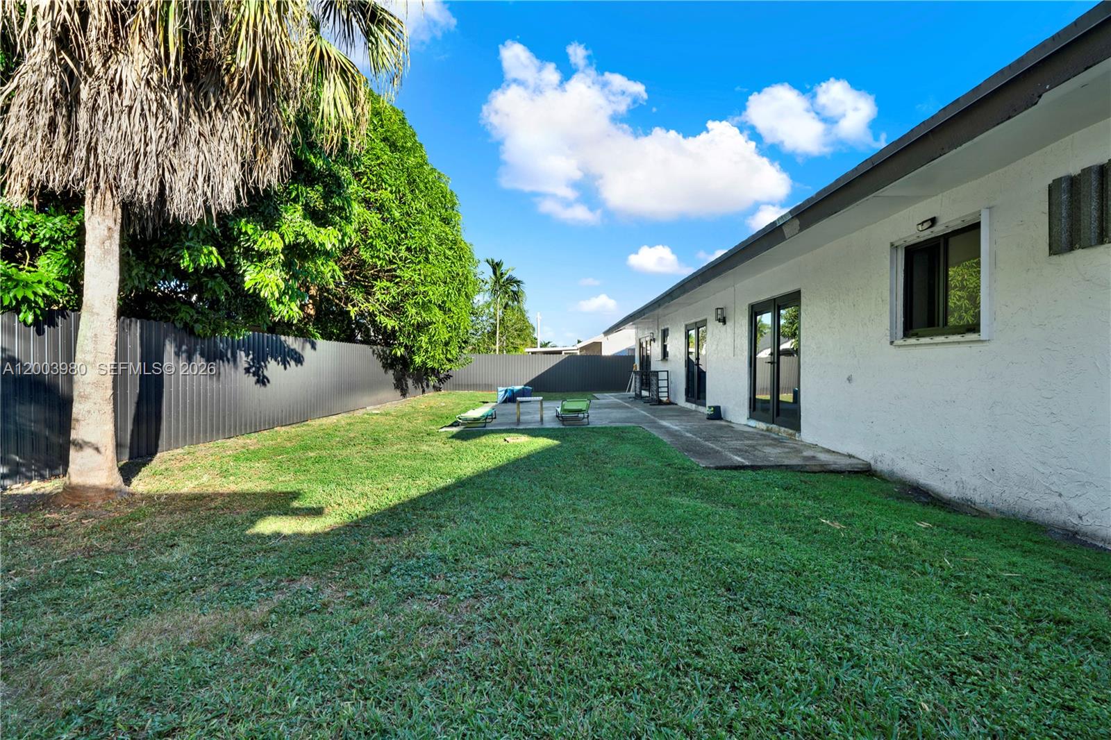 12221 Southwest 93rd Street Miami, FL 33186 - Photo 18 of 41 a view of a house with backyard and a sitting area