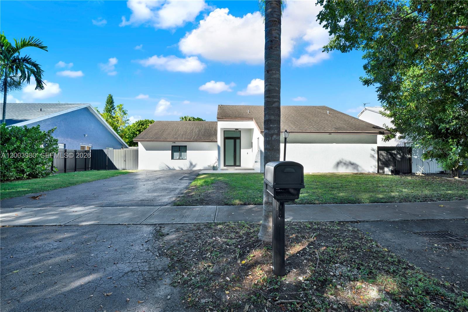 12221 Southwest 93rd Street Miami, FL 33186 - Photo 19 of 41 a front view of a house with garden