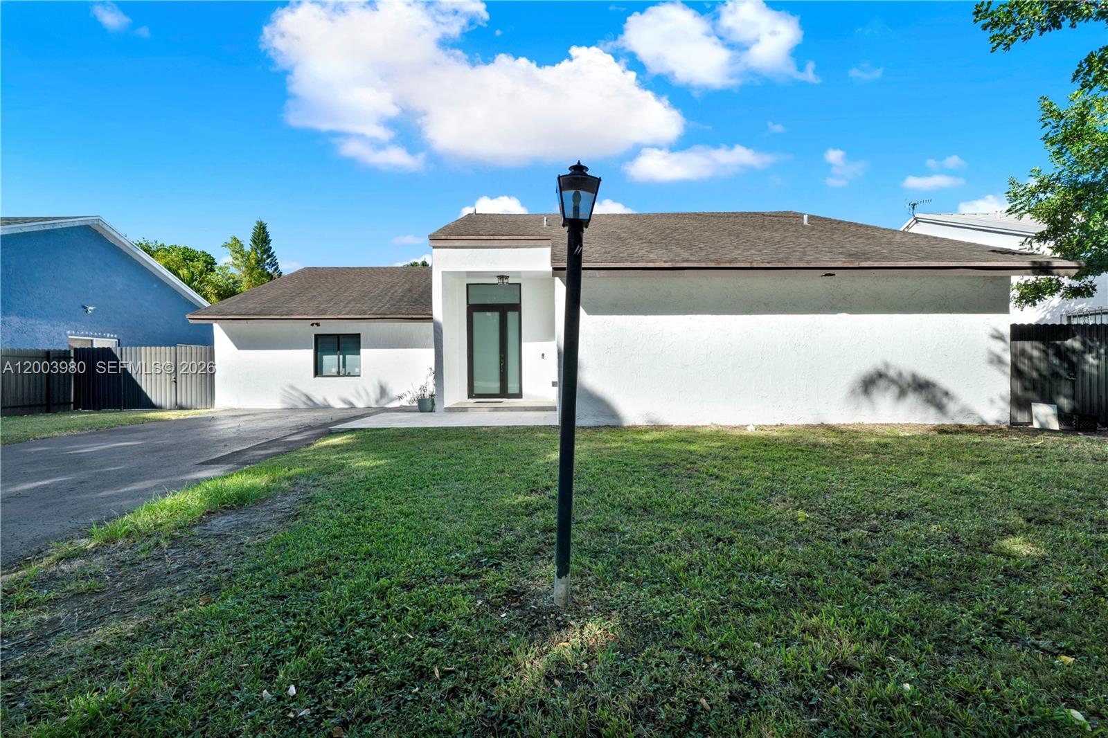12221 Southwest 93rd Street Miami, FL 33186 - Photo 2 of 41 a front view of a house with garden