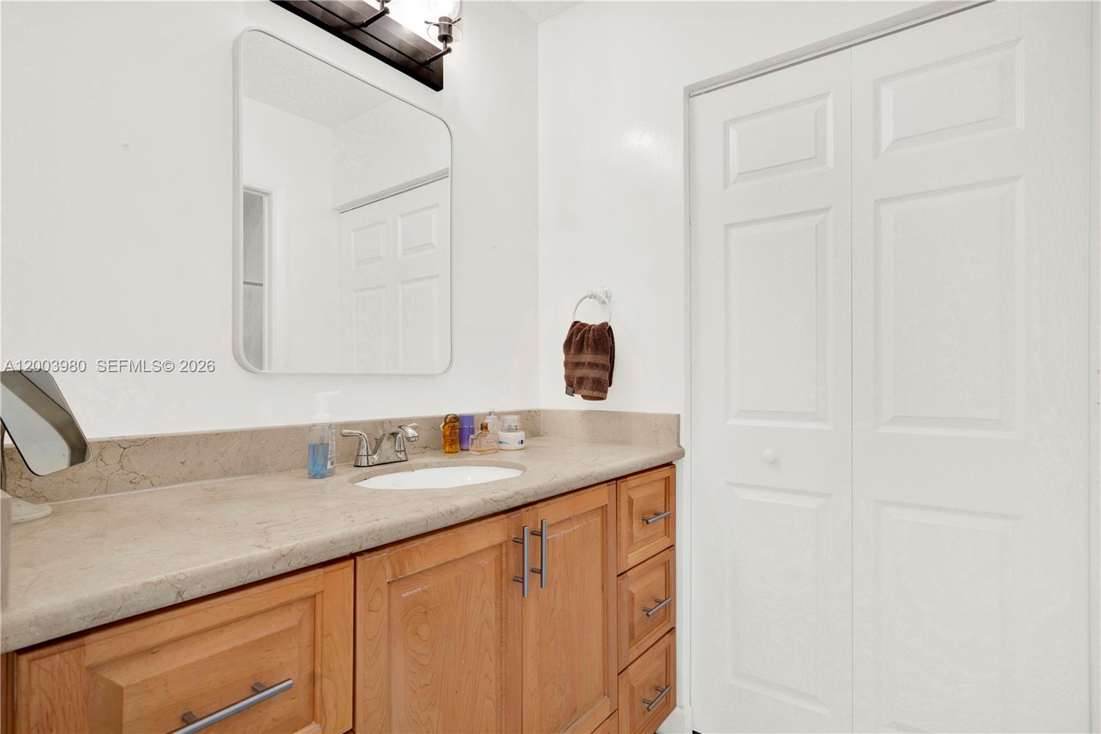 12221 Southwest 93rd Street Miami, FL 33186 - Photo 21 of 41 a bathroom with a sink and a mirror