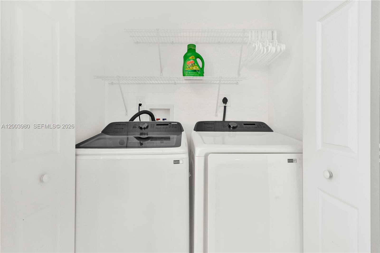 12221 Southwest 93rd Street Miami, FL 33186 - Photo 22 of 41 a kitchen with a sink a refrigerator and cabinets