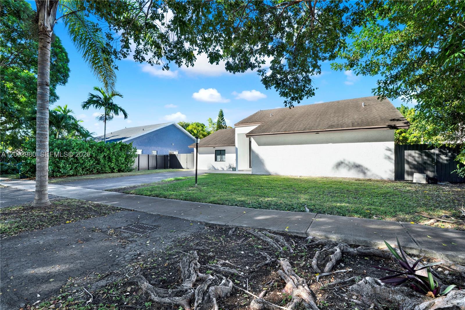 12221 Southwest 93rd Street Miami, FL 33186 - Photo 26 of 41 a front view of a house with garden