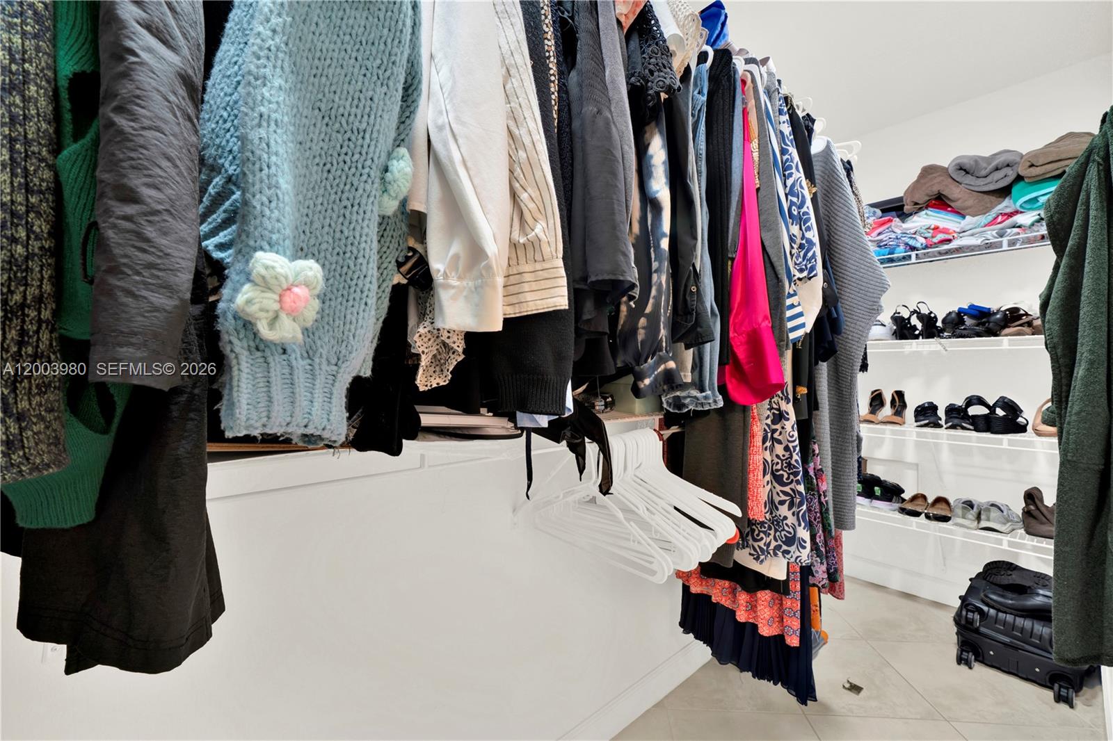 12221 Southwest 93rd Street Miami, FL 33186 - Photo 27 of 41 a view of walk in closet with clothes and shoes