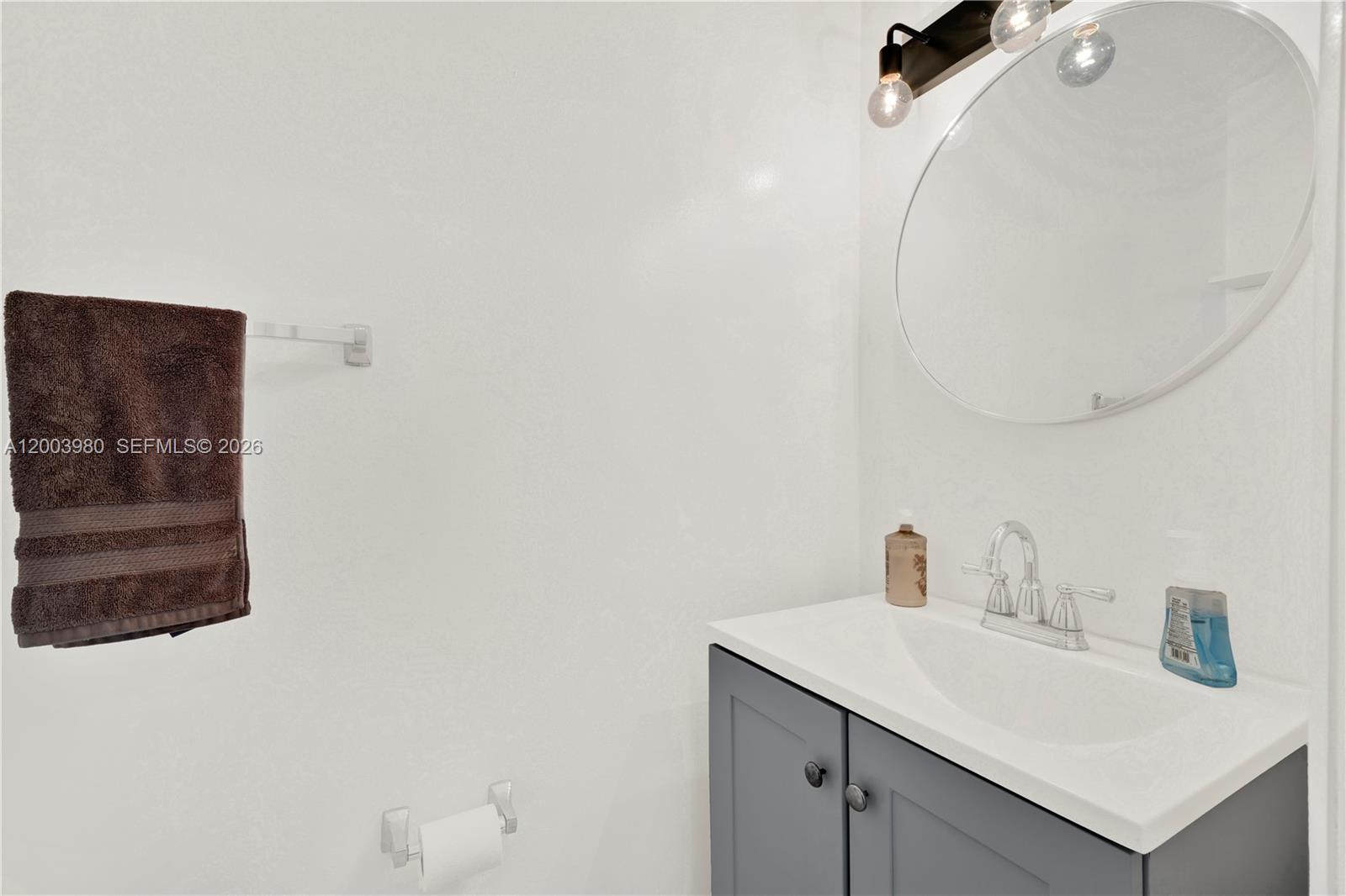 12221 Southwest 93rd Street Miami, FL 33186 - Photo 32 of 41 a bathroom with a sink and mirror