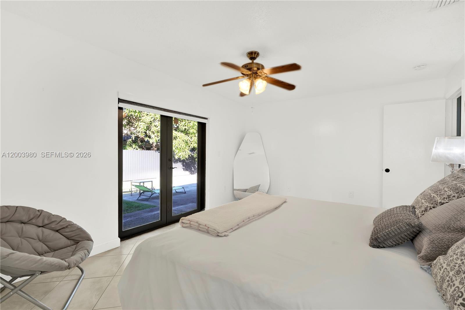 12221 Southwest 93rd Street Miami, FL 33186 - Photo 33 of 41 a bedroom with a bed and a window