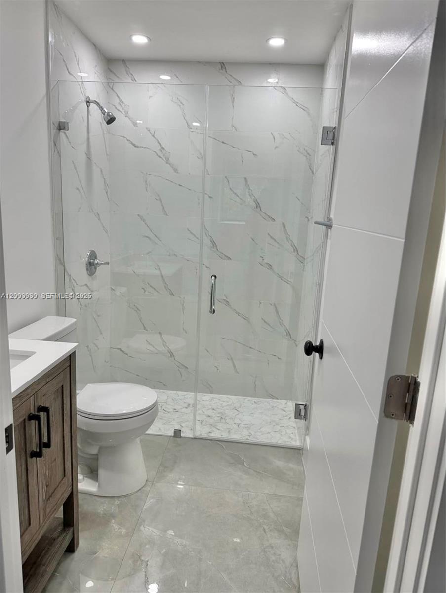 12221 Southwest 93rd Street Miami, FL 33186 - Photo 40 of 41 a bathroom with a toilet sink and shower