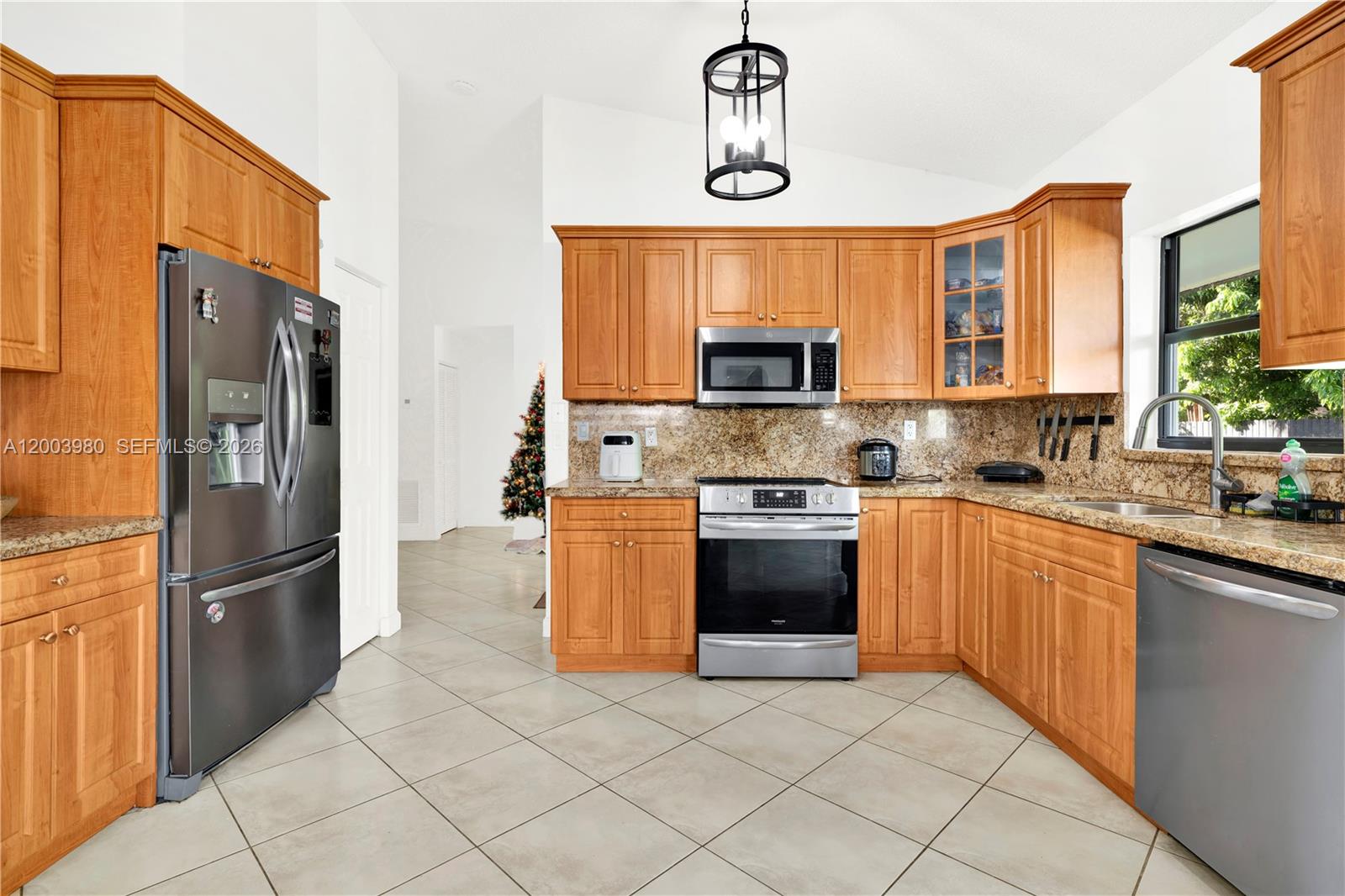 12221 Southwest 93rd Street Miami, FL 33186 - Photo 4 of 41 a kitchen with stainless steel appliances granite countertop a refrigerator and a sink