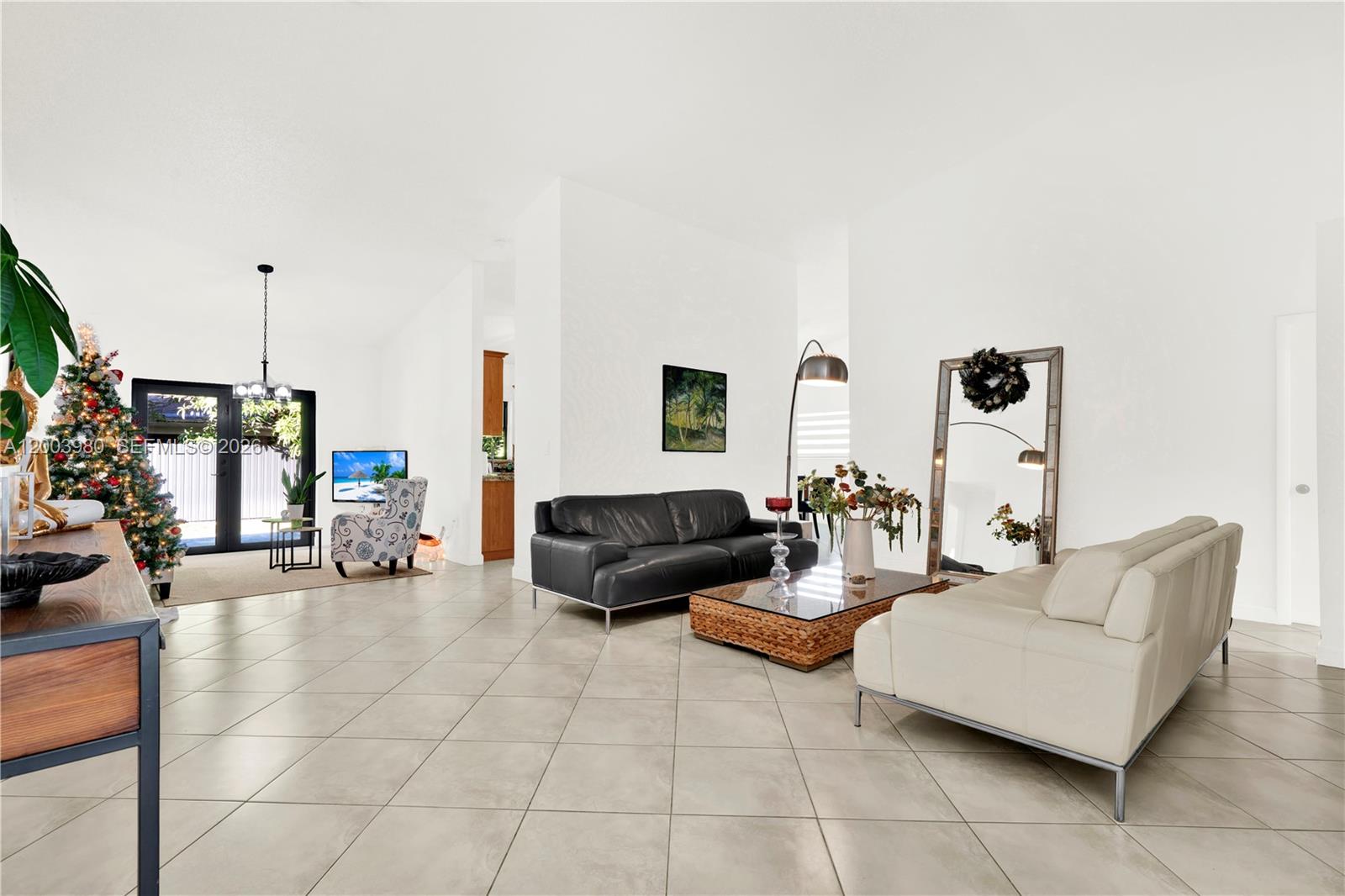 12221 Southwest 93rd Street Miami, FL 33186 - Photo 10 of 41 a living room with furniture and a flat screen tv