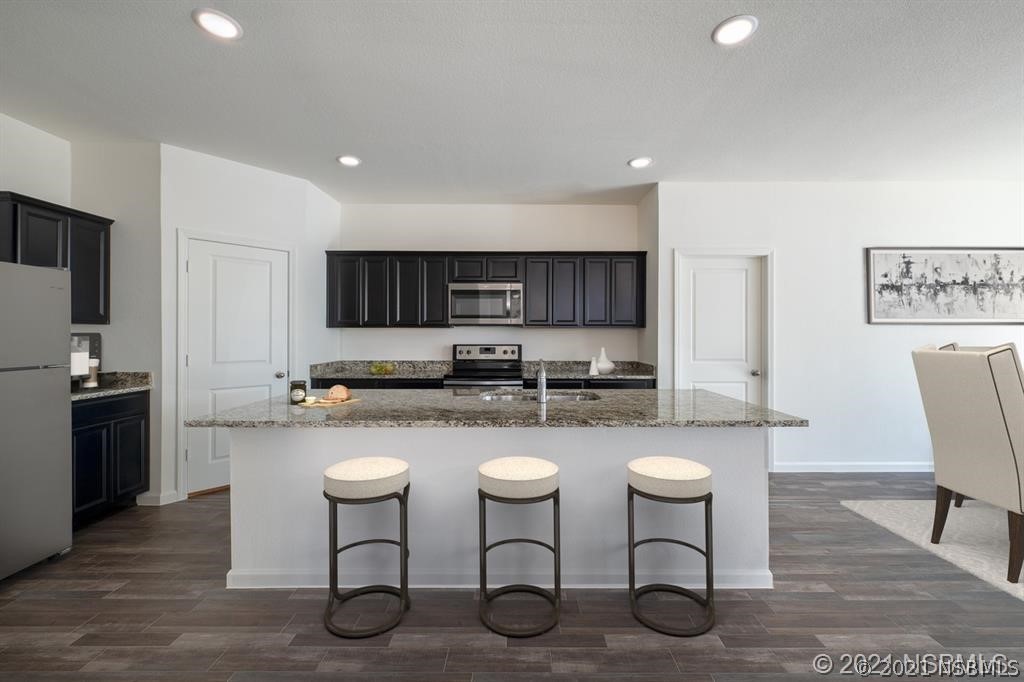 3527 Fernanda Drive Deltona, FL 32738 - Photo 4 of 9 a kitchen with sink a microwave and cabinets
