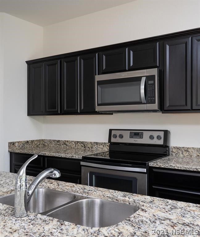 3527 Fernanda Drive Deltona, FL 32738 - Photo 5 of 9 a kitchen with a sink stove and microwave