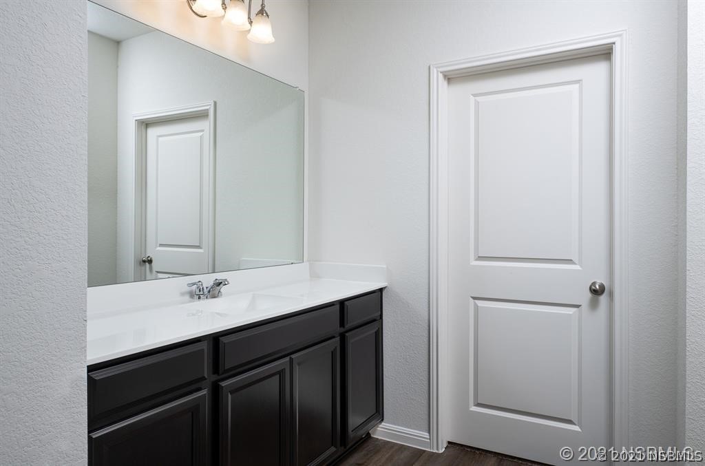 3527 Fernanda Drive Deltona, FL 32738 - Photo 8 of 9 a bathroom with a sink and a mirror