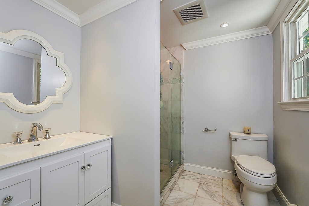 236 Hayward Mill Road Concord, MA 01742 - Photo 12 of 26 a bathroom with a toilet a sink a mirror and a shower